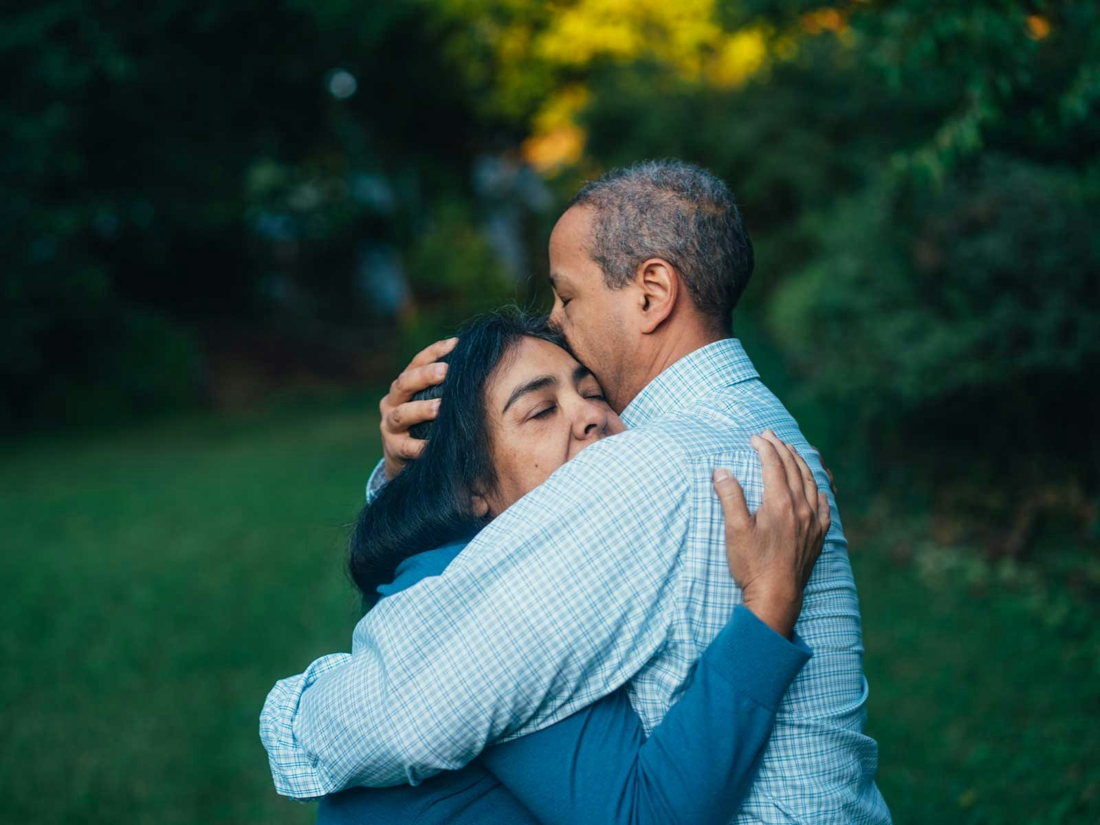 A couple shares an emotional hug.
